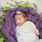 photo of baby sleeping on purple blanket