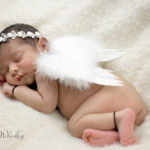 photo of sleeping baby wearing angel wings